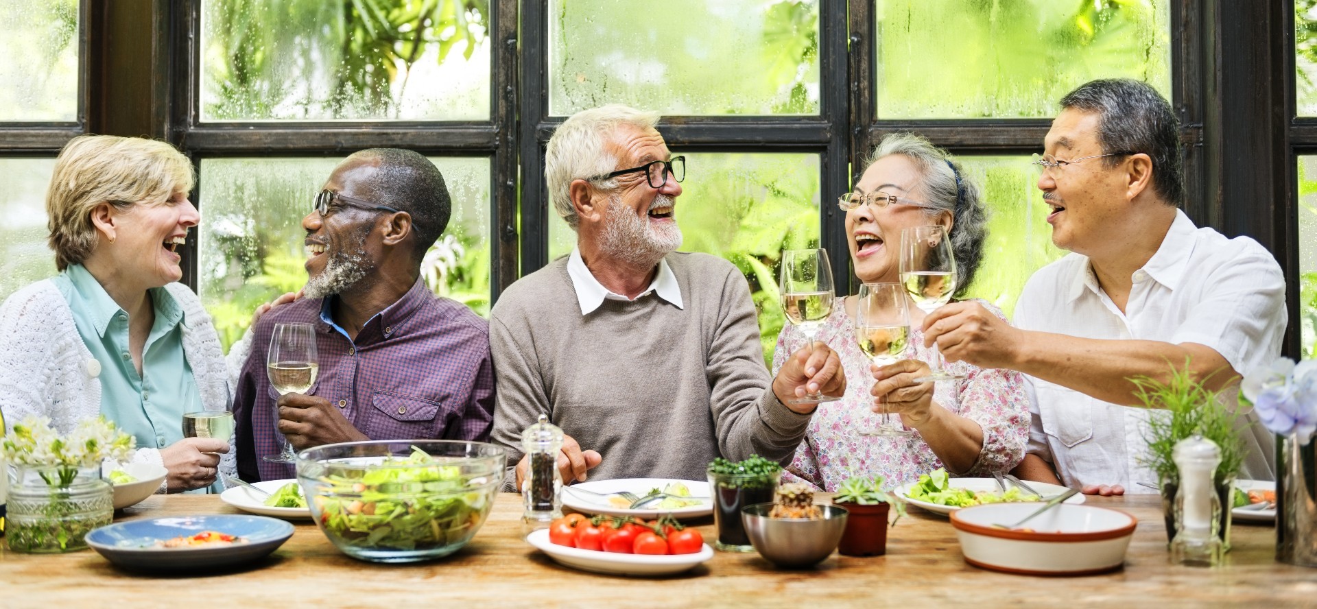 Senior friends enjoying dinner at their retirement home
