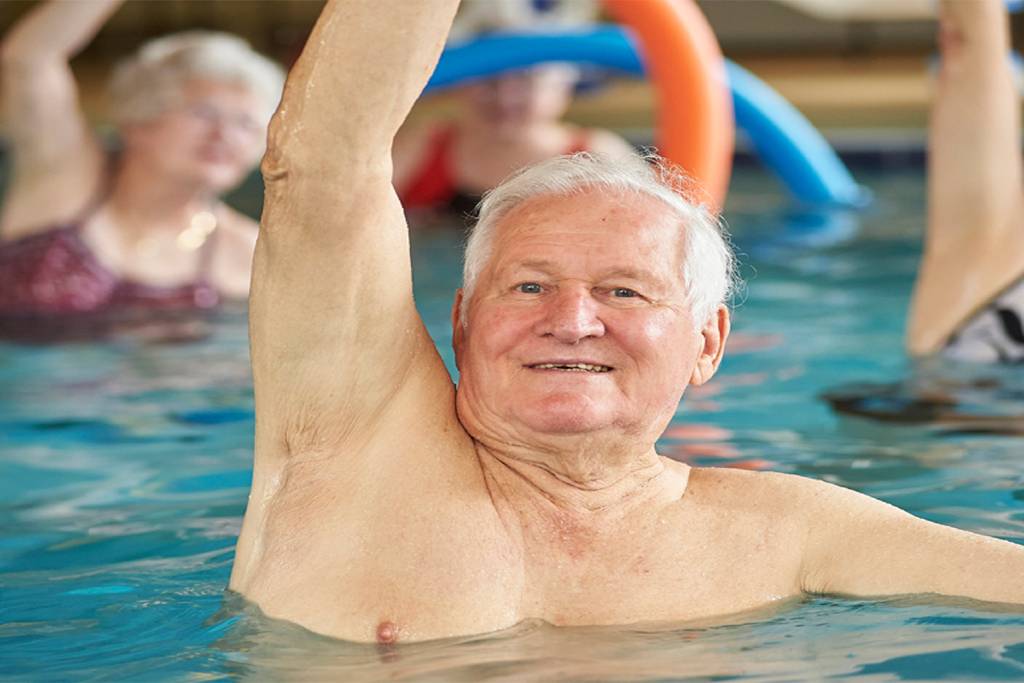 swimming for seniors offers many health benefits this man enjoys a water aerobics class
