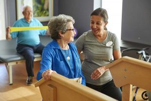 elderly woman doing physical therapy with younger woman in greenville sc rehab facility