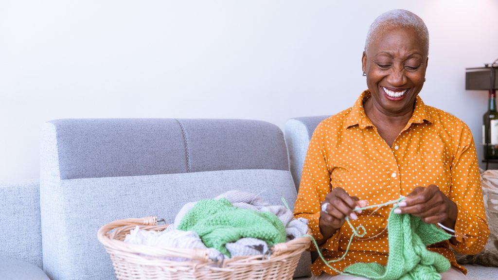senior woman knitting at home