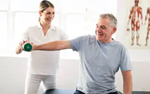 Senior doing physical rehab with weights 