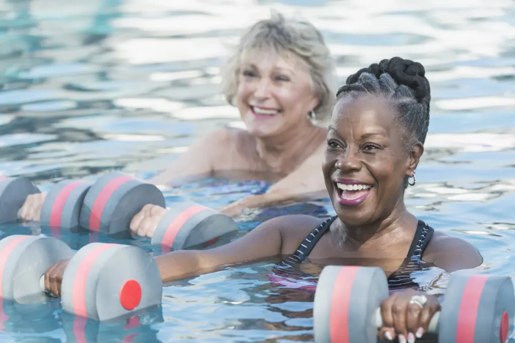 Residents participating in a wellness class in the pool at Rolling Green Village