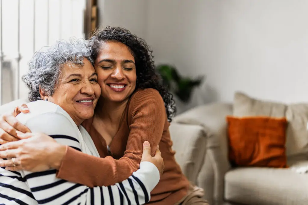 Adult woman hugging senior mom after finding right care for assisted living vs. nursing home in Greenville, SC