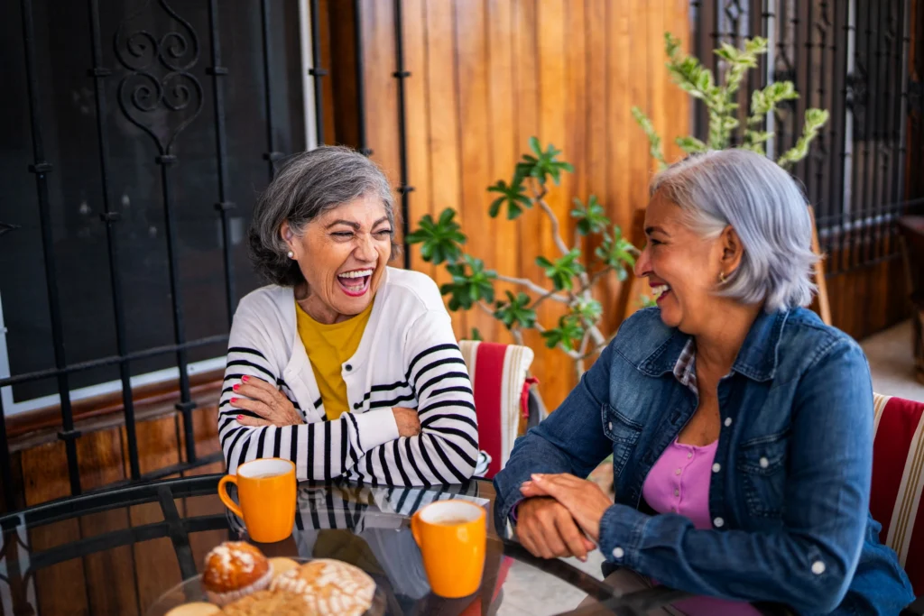 two women enjoying breakfast, discussing active adult communities in Greenville SC, options like Rolling Green Village.
