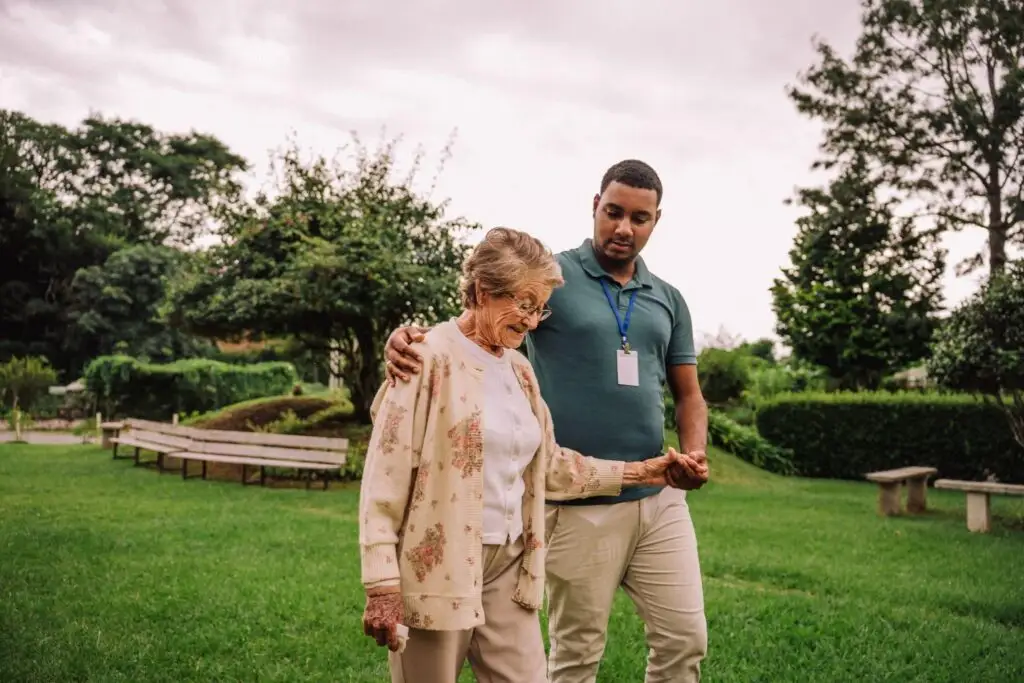 A staff member of a Rolling Green Village help a resident from their assisted living community in Greenville, SC.